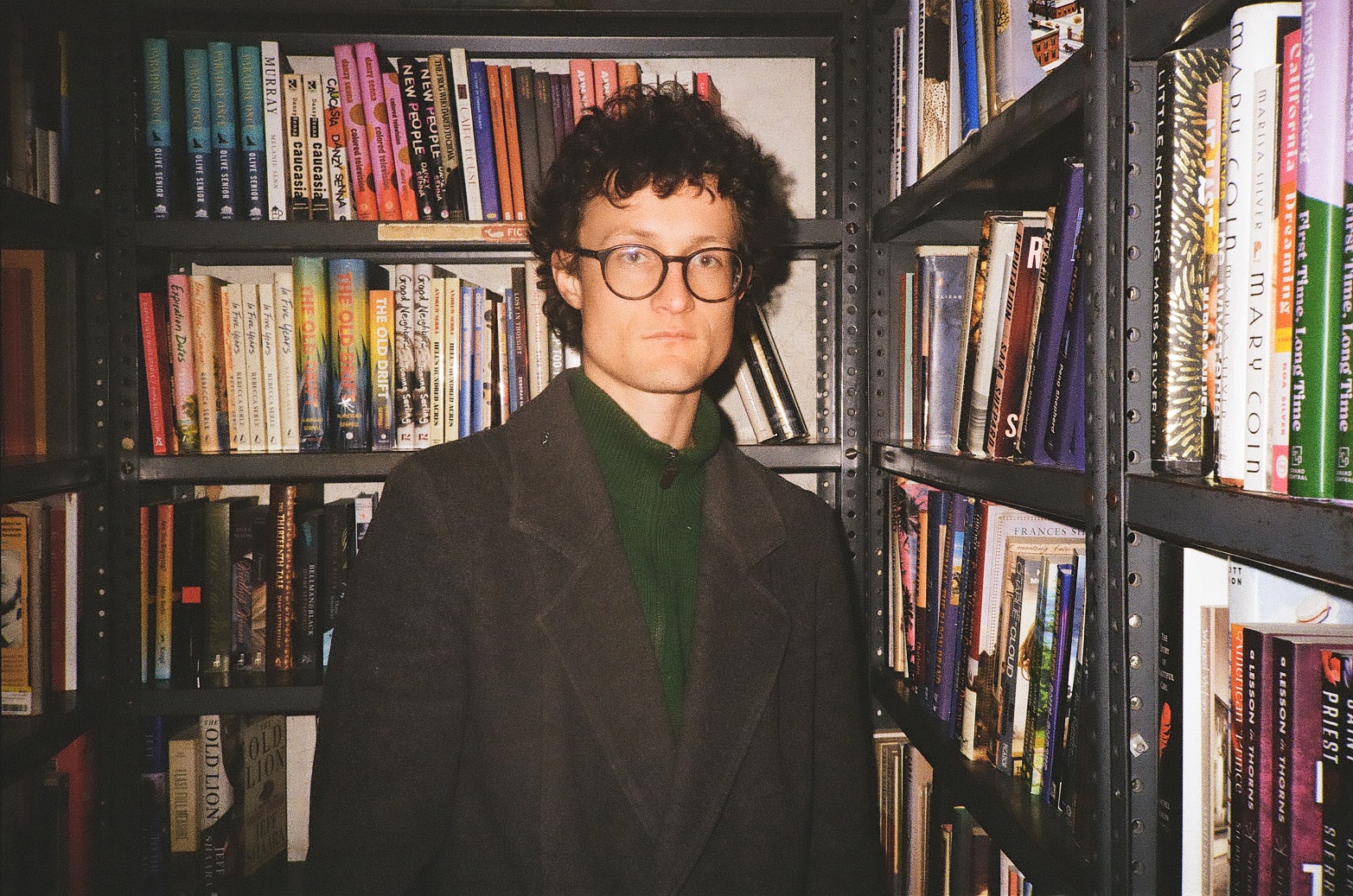 A highly professional look for Frown Town man in a library/