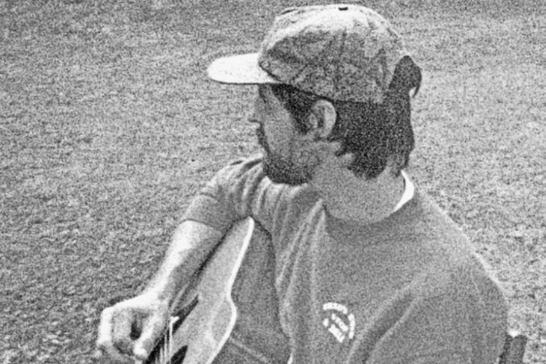 Kevin looking the other way while playing his guitar. 
