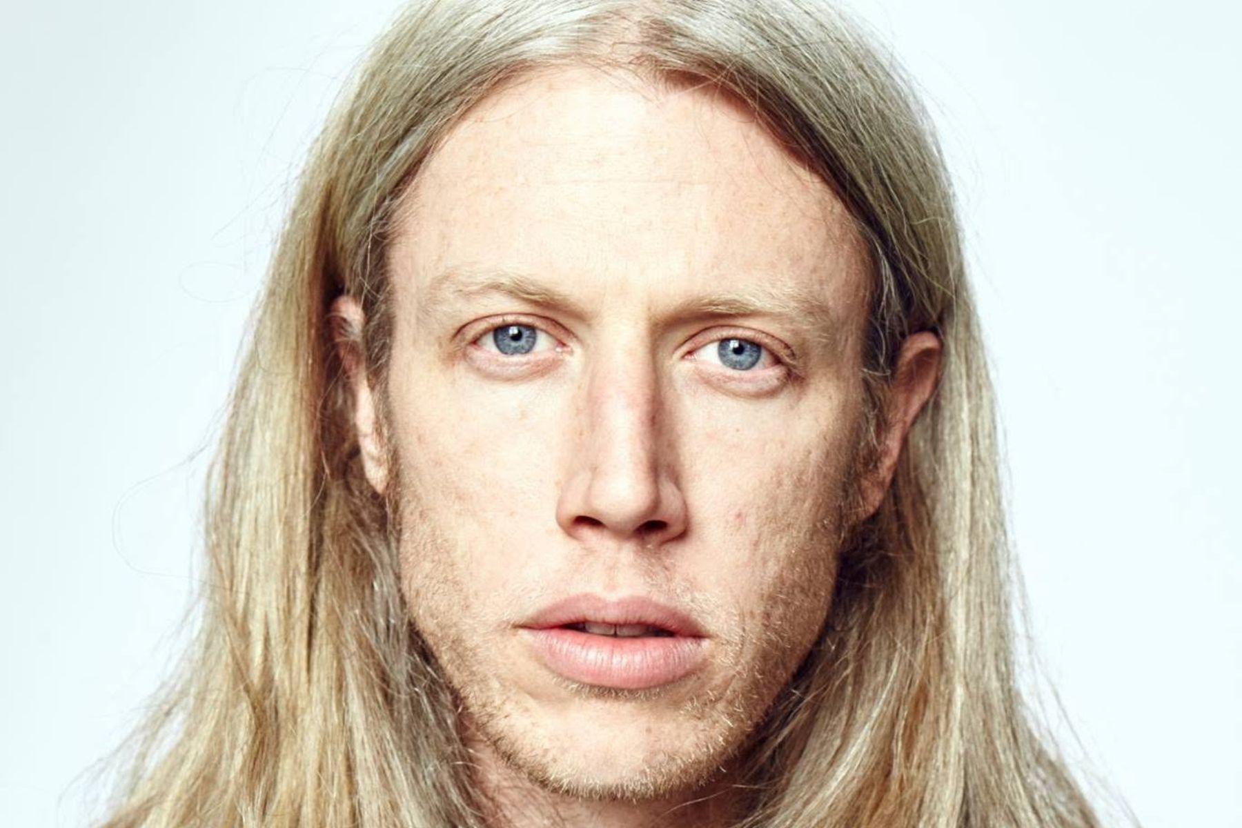 A very intimate high resolution portrait of Aaron on a white background.