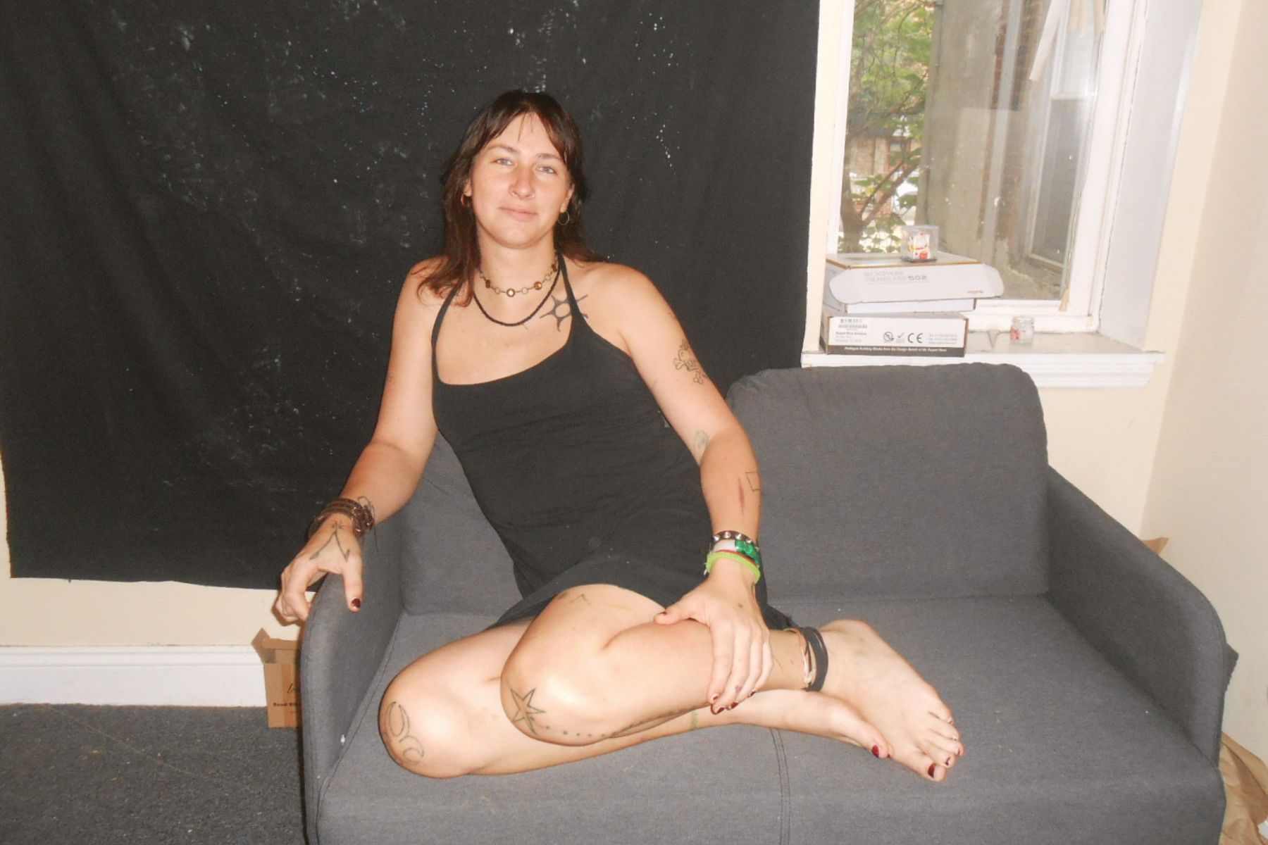 Donna sitting on a couch looking all cute